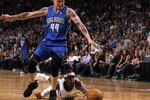 BOSTON - MAY 22:  Rajon Rondo #9 of the Boston Celtics dives for a loose ball against Jason Williams #44 of the Orlando Magic at TD Banknorth Garden in Game Three of the Eastern Conference Finals during the 2010 NBA Playoffs on May 22, 2010 in Boston, Massachusetts.  NOTE TO USER: User expressly acknowledges and agrees that, by downloading and/or using this Photograph, user is consenting to the terms and conditions of the Getty Images License Agreement.  (Photo by Elsa/Getty Images)