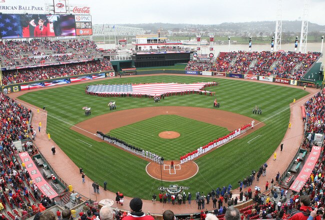 CINCINNATI, OH - APRIL 6:  Both teams line up during the National Anthem of the United States before the opening day game between the Cincinnati Reds against the New York Mets at Great American Ballpark on April 6, 2009 in Cincinnati, Ohio. (Photo by Mark Lyons/Getty Images)