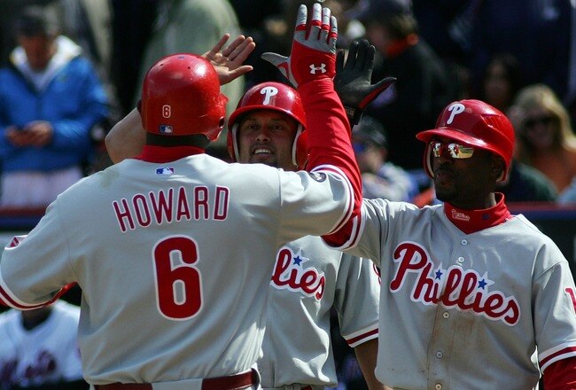 NEW YORK - APRIL 09:  Ryan Howard #6 of the Philadelphia Phillies is greeted at home by Shane Victorino #8 and Jimmy Rollins #11 after his three-run homer in the sixth inning against the New York Mets during the home opener at Shea Stadium on April 9, 2007 in the Flushing neighborhood of the Queens borough of New York City.  (Photo by Michael Heiman/Getty Images)
