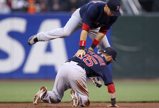 SAN FRANCISCO - JUNE 25:  Dustin Pedroia #15 and Marco Scutaro #16 of the Boston Red Sox can't handle a single hit by Eli Whiteside of the San Francisco Giants in the second inning during an MLB game at AT&T Park on June 25, 2010 in San Francisco, California.  (Photo by Jed Jacobsohn/Getty Images)