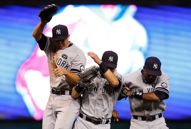 CLEVELAND - JULY 29:  Colin Curtis #27, Nick Swisher #33, and Curtis Granderson #14 of the New York Yankees celebrate in the outfield following their win against the Cleveland Indians during the game on July 29, 2010 at Progressive Field in Cleveland, Ohio.  (Photo by Jared Wickerham/Getty Images)
