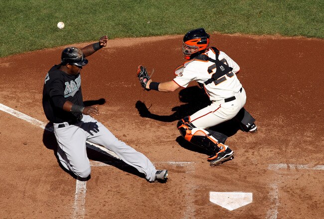 SAN FRANCISCO - JULY 28:  Hanley Ramirez #2 of the Florida Marlins scores on a double by Logan Morrison #20 after the ball got away from Buster Posey #28 of the San Francisco Giants at AT&T Park on July 28, 2010 in San Francisco, California.  (Photo by Ezra Shaw/Getty Images)
