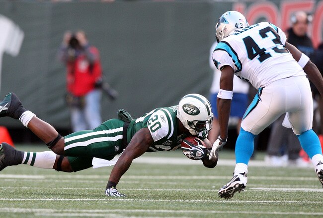 EAST RUTHERFORD, NJ - NOVEMBER 29:  Thomas Jones #20 of the New York Jets dives for extra yardage against Chris Harris #43 of the Carolina Panthers on November 29, 2009 at Giants Stadium in East Rutherford, New Jersey.  (Photo by Jim McIsaac/Getty Images)