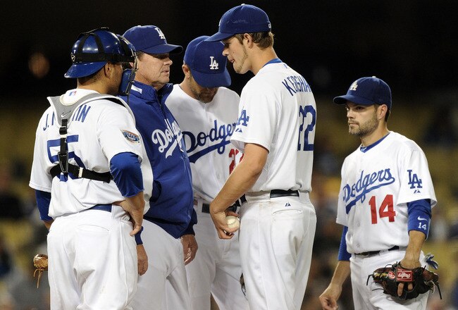 LOS ANGELES, CA - MAY 20:  Clayton Kershaw #22 of the Los Angeles Dodgers receives a visit to the mound from pitching coach Rick Honeycutt #40 and teammates against the San Diego Padres during the fifth inning at Dodger Stadium on May 20, 2010 in Los Angeles, California.  (Photo by Harry How/Getty Images)