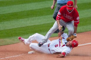 ST. LOUIS - MAY 23: Albert Pujols #5 of the St. Louis Cardinals steals third base against Brandon Wood #3 of the Los Angeles Angels of Anaheim at Busch Stadium on May 23, 2010 in St. Louis, Missouri.  The Cardinals beat the Angels 6-5 in 10 innings.  (Photo by Dilip Vishwanat/Getty Images)