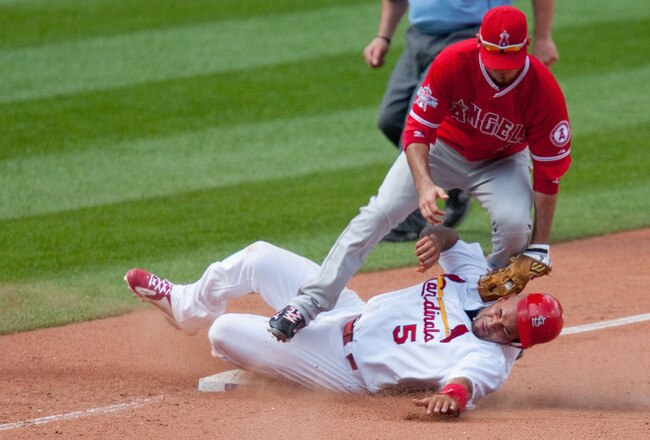 ST. LOUIS - MAY 23: Albert Pujols #5 of the St. Louis Cardinals steals third base against Brandon Wood #3 of the Los Angeles Angels of Anaheim at Busch Stadium on May 23, 2010 in St. Louis, Missouri.  The Cardinals beat the Angels 6-5 in 10 innings.  (Photo by Dilip Vishwanat/Getty Images)