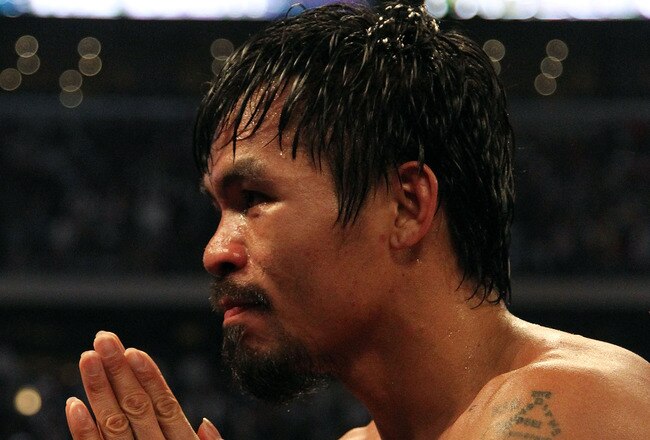 ARLINGTON, TX - MARCH 13:  Manny Pacquiao of the Philippines celebrates in the ring after defeating Joshua Clottey of Ghana during the WBO welterweight title fight at Cowboys Stadium on March 13, 2010 in Arlington, Texas. Pacquiao defeated Clottey by unanimous decision.  (Photo by Jed Jacobsohn/Getty Images)