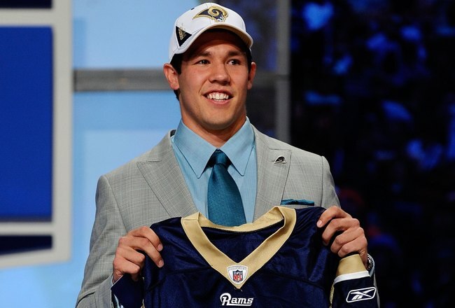 NEW YORK - APRIL 22:  Quarterback Sam Bradford from the Oklahoma Sooners holds up a St. Louis Rams jersey after the Rams selected Bradford numer 1 overall during the first round of the 2010 NFL Draft at Radio City Music Hall on April 22, 2010 in New York City.  (Photo by Jeff Zelevansky/Getty Images)