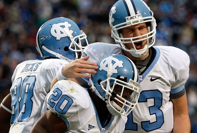 DURHAM, NC - NOVEMBER 29:  Quarterback T.J. Yates #13 of the North Carolina Tar Heels celebrates with running back Shaun Draughn #20 after Draughn's touchdown against the Duke Blue Devils during the game at Wallace Wade Stadium on November 29, 2008 in Durham, North Carolina.  (Photo by Kevin C. Cox/Getty Images)