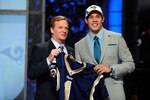 NEW YORK - APRIL 22:  Quarterback Sam Bradford of the Oklahoma Sooners holds up a St. Louis Rams jersey as he stands with NFL Commissioner Roger Goodell after Bradford was picked numer 1 overall by the Rams during the 2010 NFL Draft at Radio City Music Hall on April 22, 2010 in New York City.  (Photo by Jeff Zelevansky/Getty Images)