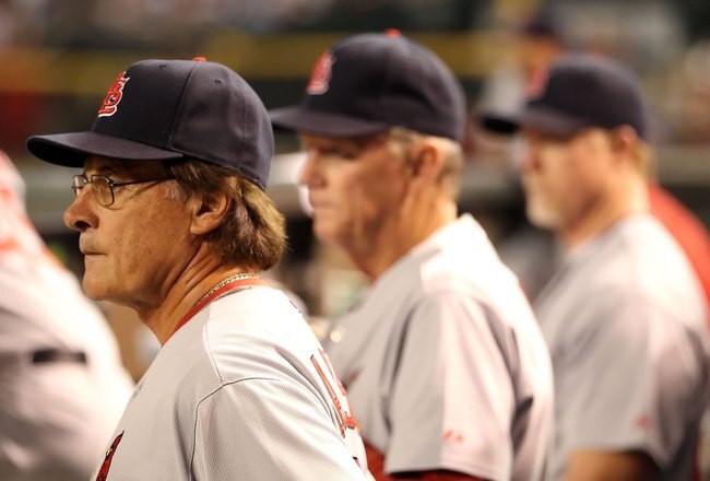 PHOENIX - JUNE 11:  Manager Tony La Russa #10 of the St. Louis Cardinals stands with Dave Duncan #18 and Mark McGwire #25 in the dugout during the Major League Baseball game against the Arizona Diamondbacks at Chase Field on June 11, 2010 in Phoenix, Arizona. The Cardinals defeated the Diamondbacks 5-2.  (Photo by Christian Petersen/Getty Images)