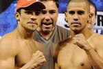 LAS VEGAS - JULY 30:  WBA/WBO lightweight champion Juan Manuel Marquez (L) and Juan Diaz (R) pose during their official weigh-in at the Mandalay Bay Events Center as Golden Boy Promotions President Oscar De La Hoya (C) looks on July 30, 2010 in Las Vegas, Nevada. Marquez will defend his titles against Diaz on July 31 in Las Vegas.  (Photo by Ethan Miller/Getty Images)