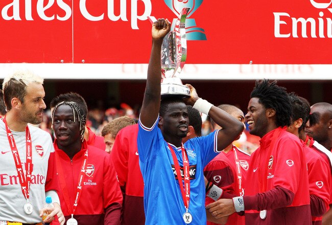 LONDON, ENGLAND - AUGUST 02:  Emmanuel Eboue of Arsenal celebrates with the Trophy following his team's victory during the Emirates Cup match between Arsenal and Glasgow Rangers at the Emirates Stadium on August 2, 2009 in London, England.  (Photo by Phil Cole/Getty Images)