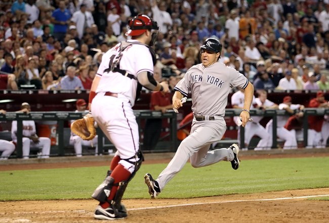 PHOENIX - JUNE 22:  Mark Teixeira #25 of the New York Yankees scores a run past catcher Chris Snyder #19 of the Arizona Diamondbacks during the Major League Baseball game at Chase Field on June 22, 2010 in Phoenix, Arizona.   The Yankees defeated the Diamondbacks 9-3.  (Photo by Christian Petersen/Getty Images)
