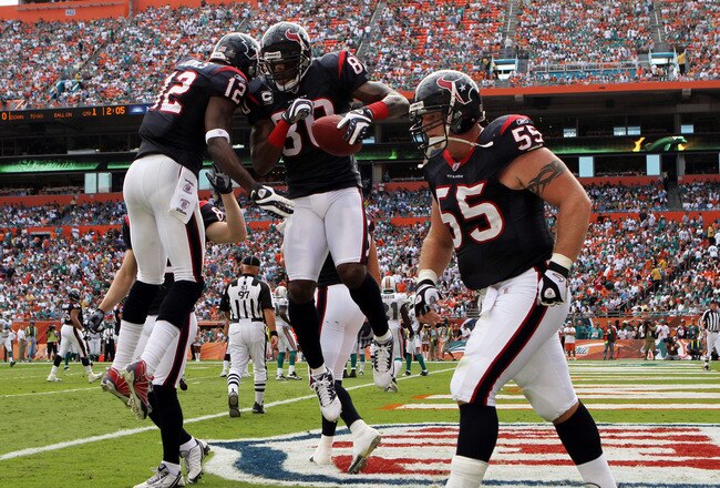 MIAMI - DECEMBER 27:  Wide receivers Andre Johnson #80 and Jacoby Jones #12 of the Houston Texans after Johnson scored a touchdown against the Miami Dolphins at Land Shark Stadium on December 27, 2009 in Miami, Florida. The Texans defeated the Dolphins 27-20. (Photo by Doug Benc/Getty Images)