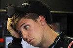 LONG POND, PA - JULY 31:  Denny Hamlin, driver of the #11 FedEx Office Toyota, stands in the garage during practice for the NASCAR Sprint Cup Series Sunoco Red Cross Pennsylvania 500 at Pocono Raceway on July 31, 2010 in Long Pond, Pennsylvania.  (Photo by Chris Trotman/Getty Images for NASCAR)