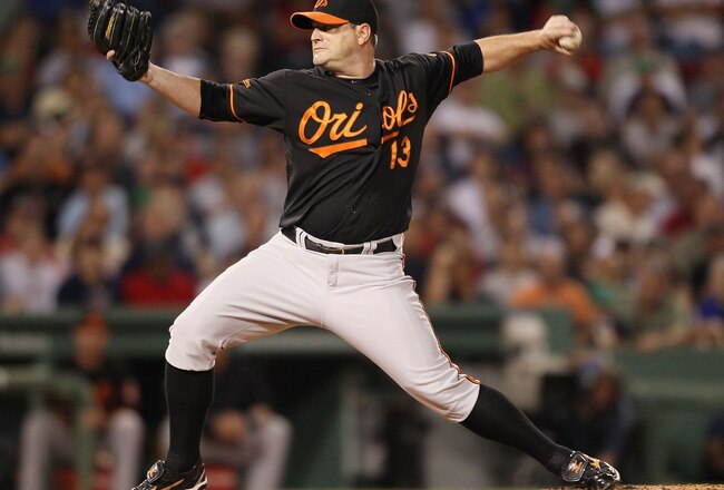 BOSTON - JULY 02:  Will Ohman #13 of the Baltimore Orioles delivers a pitch in the eighth inning against the Boston Red Sox on July 2, 2010 at Fenway Park in Boston, Massachusetts.  (Photo by Elsa/Getty Images)