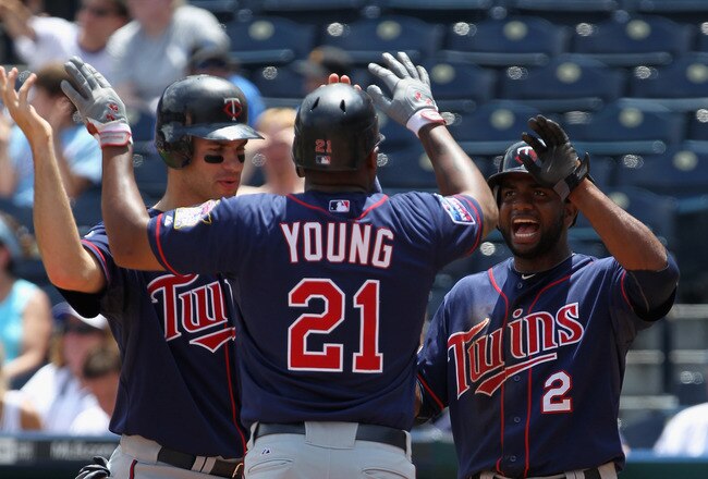 KANSAS CITY, MO - JULY 28:  Delmon Young #21 of the Minnesota Twins is congratulated by Joe Mauer #7 and Denard Span #2 after hitting a 3-run home run during the 1st inning of the game against the Kansas City Royals on July 28, 2010 at Kauffman Stadium in Kansas City, Missouri.  (Photo by Jamie Squire/Getty Images)