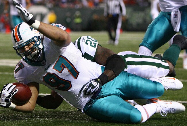 EAST RUTHERFORD, NJ - DECEMBER 28: Phillip Merling #97 of The Miami Dolphins rumbles in for a touchdown after making an interception thrown by Brett Favre of The New York Jets during their game on December 28, 2008 at Giants Stadium in East Rutherford, New Jersey. (Photo by Al Bello/Getty Images)