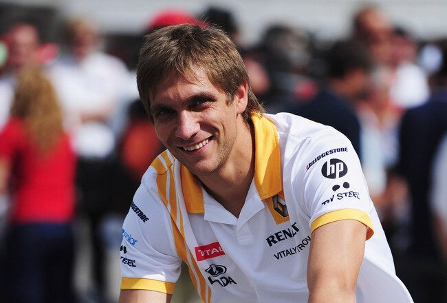 BUDAPEST, HUNGARY - JULY 29:  Vitaly Petrov of Russia and Renault rides his bike in the paddock during previews to the Hungarian Formula One Grand Prix at the Hungaroring on July 29, 2010 in Budapest, Hungary.  (Photo by Clive Mason/Getty Images)