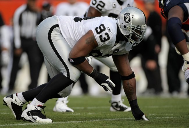 DENVER - NOVEMBER 23:  Defensive tackle Tommy Kelly #93 of the Oakland Raiders defends against the Denver Broncos during week 12 NFL action at Invesco Field at Mile High on November 23, 2008 in Denver, Colorado. The Raiders defeated the Broncos 31-10.  (Photo by Doug Pensinger/Getty Images)