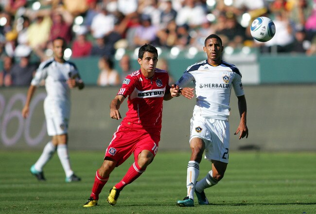 CARSON, CA - AUGUST 01:  Sean Franklin #28 of the Los Angeles Galaxy passes the ball under pressure from Marco Pappa #16 of the Chicago Fire during their MLS match at The Home Depot Center on August 1, 2010 in Carson, California.  (Photo by Victor Decolongon/Getty Images)