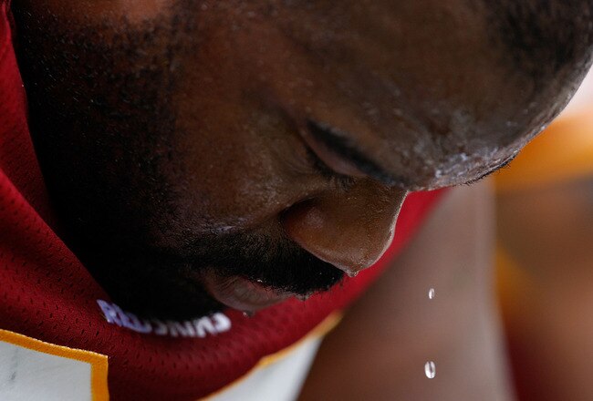 CHARLOTTE, NC - OCTOBER 11:  Albert Haynesworth #92 of Washington Redskins watches a drop of sweat as he waits on the bench against the Carolina Panthers at Bank of America Stadium on October 11, 2009 in Charlotte, North Carolina.  (Photo by Streeter Lecka/Getty Images)