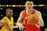 LOS ANGELES, CA - MAY 06:  Yao Ming #11 of the Houston Rockets moves the ball against Andrew Bynum #17 of the Los Angeles Lakers in Game Two of the Western Conference Semifinals during the 2009 NBA Playoffs at Staples Center on May 6, 2009 in Los Angeles, California. NOTE TO USER: User expressly acknowledges and agrees that, by downloading and or using this photograph, User is consenting to the terms and conditions of the Getty Images License Agreement.  (Photo by Harry How/Getty Images)