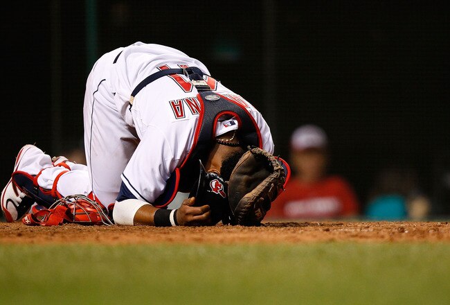 CLEVELAND - JULY 29:  Carlos Santana #41 of the Cleveland Indians grimaces in pain after a ball hit him in the knee during the game against the New York Yankees on July 29, 2010 at Progressive Field in Cleveland, Ohio.  (Photo by Jared Wickerham/Getty Images)