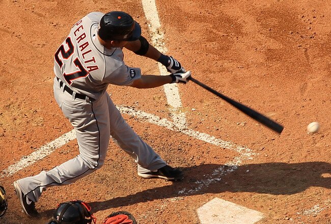 BOSTON - AUGUST 01:  Jhonny Peralta #27 of the Detroit Tigers hits an RBI single as Victor Martinez #41 of the Boston Red Sox defends on August 1, 2010 at Fenway Park in Boston, Massachusetts. The Red Sox defeated the Tigers 4-3.  (Photo by Elsa/Getty Images)