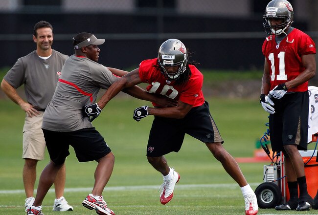 TAMPA, FL - MAY 01:  Head coach Raheem Morris of the Tampa Bay Buccaneers works with receiver Chris Bonner #10 during the Buccaneers Rookie mini camp at One Buccaneer Place on May 1, 2010 in Tampa, Florida.  (Photo by J. Meric/Getty Images)