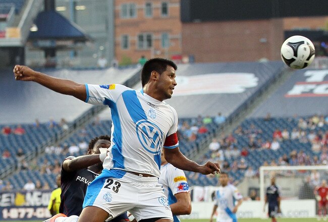 FOXBORO, MA - AUGUST 04:  Joaquin Velasquez #23 of Puebla FC and Kenny Mansally #7 of the New England Revolution battle for the ball during the SuperLiga 2010 on August 4, 2010 at Gillette Stadium in Foxboro, Massachusetts.  (Photo by Elsa/Getty Images)