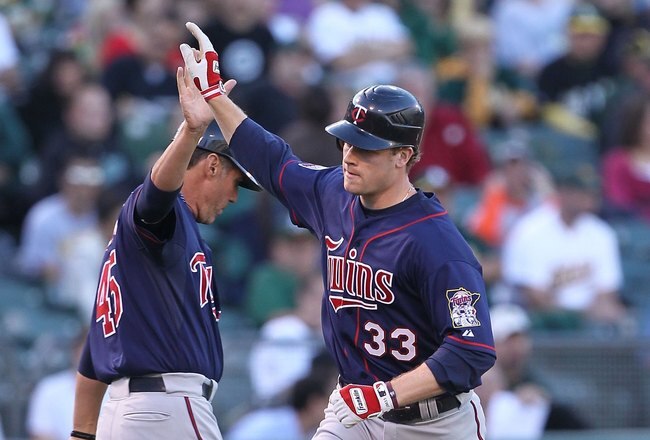 OAKLAND, CA - JUNE 04:  Justin Morneau #33 of the Minnesota Twins celebrates after hitting a two run home run against the Oakland Athletics in the first inning during an MLB game at the Oakland-Alameda County Coliseum on June 4, 2010 in Oakland, California.  (Photo by Jed Jacobsohn/Getty Images)