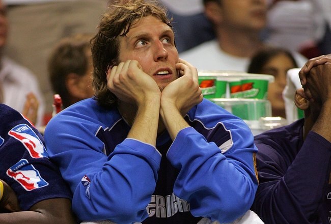 MIAMI - JUNE 15:  Dirk Nowitzki #41 of the Dallas Mavericks sits on the bench late in the game against the Miami Heat in game four of the 2006 NBA Finals on June 15, 2006 at American Airlines Arena in Miami, Florida. The Heat defeated the Mavericks 98-74 to even the series at 2-2.   NOTE TO USER: User expressly acknowledges and agrees that, by downloading and or using this photograph, User is consenting to the terms and conditions of the Getty Images License Agreement.  (Photo by Stephen Dunn/Getty Images)
