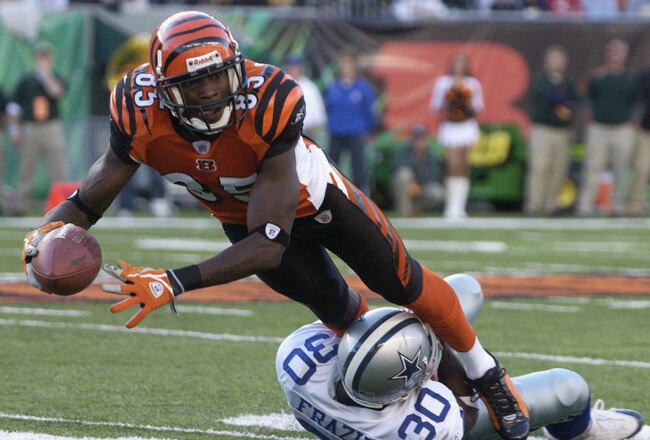 CINCINNATI - NOVEMBER 7:  Wide receiver Chad Johnson #85 of the Cincinnati Bengals is tackled by cornerback Lance Frazier #30 of the Dallas Cowboys during the game at Paul Brown Stadium on November 7, 2004 in Cincinnati, Ohio. The Bengals defeated the Cowboys 26-3. (Photo by Andy Lyons/Getty Images)