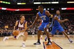 PHOENIX - DECEMBER 11:  Steve Nash #13 of the Phoenix Suns handles the ball under pessure from Dwight Howard #12 of the Orlando Magic during the NBA game at US Airways Center on December 11, 2009 in Phoenix, Arizona. The Suns defeated the Magic 106-103.  NOTE TO USER: User expressly acknowledges and agrees that, by downloading and or using this photograph, User is consenting to the terms and conditions of the Getty Images License Agreement.  (Photo by Christian Petersen/Getty Images)
