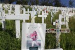LAFAYETTE, CA - MARCH 19:  A photograph of former NFL football player and war veteran Pat Tillman is displayed on a wooden cross at a roadside memorial that features over 5,000 wooden crosses which represent U.S. troops that have been killed in Iraq March 19, 2010 in Lafayette, California. Today marks the seven year anniversary of the U.S. led war in Iraq.  (Photo by Justin Sullivan/Getty Images)