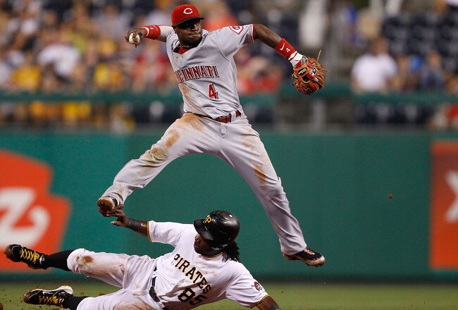PITTSBURGH - AUGUST 03:  Brandon Phillips #4 of the Cincinnati Reds attempts to turn the double play over Lastings Milledge #85 of the Pittsburgh Pirates during the game on August 3, 2010 at PNC Park in Pittsburgh, Pennsylvania.  (Photo by Jared Wickerham/Getty Images)