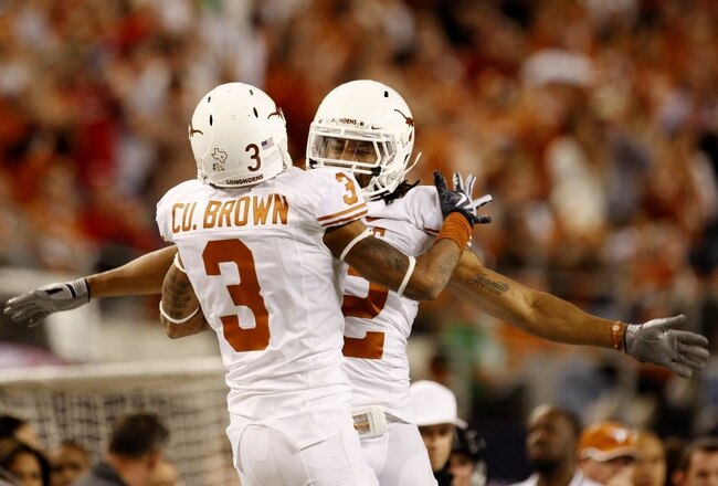 ARLINGTON, TX - DECEMBER 5:  Curtis Brown #3 and Earl Thomas #12 of the Texas Longhorns celebrate breaking up a pass against the Nebraska Cornhuskers in the third quarter at Cowboys Stadium on December 5, 2009 in Arlington, Texas.  (Photo by Ronald Martinez/Getty Images)