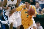TAMPA, FL - MARCH 23:  Chris De La Rosa #0 of the Siena Saints brings the ball upcourt as he is guarded by Reggie Redding #15 of the Villanova Wildcats in the second round of the 2008 NCAA Tournament Midwest Regional at the St. Pete Times Forum on March 23, 2008 in Tampa, Florida.  (Photo by Doug Benc/Getty Images)