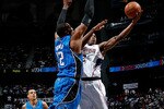 ATLANTA - MAY 10:  Dwight Howard #12 of the Orlando Magic defends the basket against Joe Johnson #2 of the Atlanta Hawks during Game Four of the Eastern Conference Semifinals of the 2010 NBA Playoffs at Philips Arena on May 10, 2010 in Atlanta, Georgia.  NOTE TO USER: User expressly acknowledges and agrees that, by downloading and/or using this Photograph, User is consenting to the terms and conditions of the Getty Images License Agreement.  (Photo by Kevin C. Cox/Getty Images)