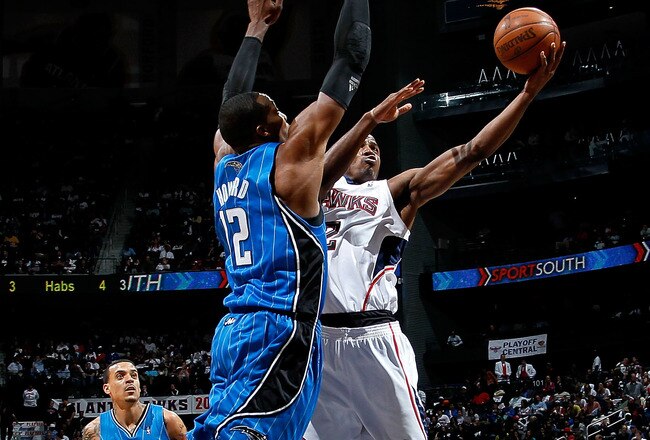 ATLANTA - MAY 10:  Dwight Howard #12 of the Orlando Magic defends the basket against Joe Johnson #2 of the Atlanta Hawks during Game Four of the Eastern Conference Semifinals of the 2010 NBA Playoffs at Philips Arena on May 10, 2010 in Atlanta, Georgia.  NOTE TO USER: User expressly acknowledges and agrees that, by downloading and/or using this Photograph, User is consenting to the terms and conditions of the Getty Images License Agreement.  (Photo by Kevin C. Cox/Getty Images)