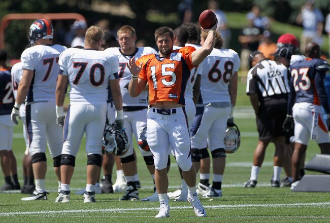 ENGLEWOOD, CO - AUGUST 05:  Rookie quarterback Tim Tebow #15 of the Denver Bronocs tosses the ball as he takes part in practice during training camp at Dove Valley on August 5, 2010 in Englewood, Colorado.  (Photo by Doug Pensinger/Getty Images)