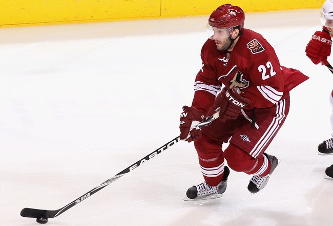 GLENDALE, AZ - APRIL 23:  Lee Stempniak #22 of the Phoenix Coyotes skates with the puck past Daniel Cleary #11 of the Detroit Red Wings in Game Five of the Western Conference Quarterfinals during the 2010 NHL Stanley Cup Playoffs at Jobing.com Arena on April 23, 2010 in Glendale, Arizona. The Red Wings defeated the Coyotes 4-1 to take a 3-2 series lead. (Photo by Christian Petersen/Getty Images)