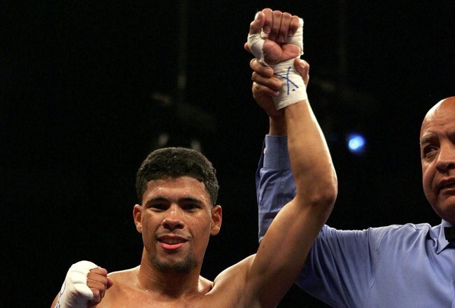 LAS VEGAS - JANUARY 21:  Juan Manuel Lopez of Puerto Rico raises his arm in victory after his defeat of Jose Luis Caro of Mexico during their Featherweight fight at Thomas & Mack Arena on January 21, 2006 in Las Vegas, Nevada. Lopez knocked out Caro in the third round.  (Photo by Jed Jacobsohn/Getty Images)