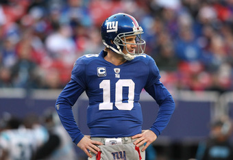 EAST RUTHERFORD, NJ - DECEMBER 27:  Eli Manning #10 of the New York Giants stands on the field  against the Carolina Panthers at Giants Stadium on December 27, 2009 in East Rutherford, New Jersey.  (Photo by Nick Laham/Getty Images)