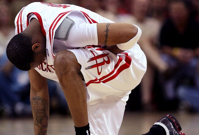 HOUSTON - APRIL 19:  Tracy McGrady #1 of the Houston Rockets kneels and holds his stomach after being fouled against the Utah Jazz in Game One of the Western Conference Quarterfinals during the 2008 NBA Playoffs at the Toyota Center on April 19, 2008 in Houston, Texas.  The Jazz won 93-82.  NOTE TO USER: User expressly acknowledges and agrees that, by downloading and or using this photograph, User is consenting to the terms and conditions of the Getty Images License Agreement.  (Photo by Stephen Dunn/Getty Images)