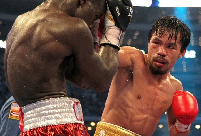 ARLINGTON, TX - MARCH 13:  (R-L) Manny Pacquiao of the Philippines throws a right to the head of Joshua Clottey of Ghana during the WBO welterweight title fight at Cowboys Stadium on March 13, 2010 in Arlington, Texas. Pacquiao defeated Clottey by unanimous decision.  (Photo by Jed Jacobsohn/Getty Images)