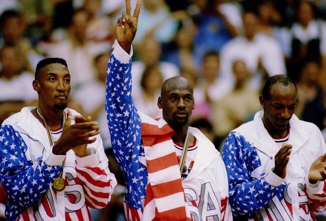 6 OCT 1992:  USA BASKETBALL TEAM MEMBERS MICHAEL JORDAN (MIDDLE) SCOTTIE PIPPEN (LEFT) AND CLIDE DREXLER (RIGHT) ACKNOWLEDGE THE CROWD AFTER RECEIVING THEIR GOLD MEDALAS MEMBERS OF THE DREAM TEAM DURING THE 1992 BARCELONA OLYMPICS IN BARCELONA, SPAIN. Man