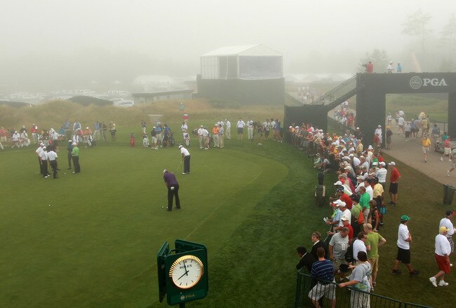 KOHLER, WI - AUGUST 12:  Players putt on the practice green while fans look on during a weather delay before the first round of the 92nd PGA Championship on the Straits Course at Whistling Straits on August 12, 2010 in Kohler, Wisconsin.  (Photo by Andrew Redington/Getty Images)